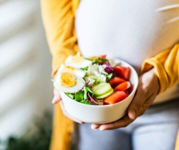 Pregnant woman choosing healthy foods rich in essential nutrients