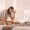 New mom gently looking at her postpartum body in the mirror, embracing changes after childbirth with confidence