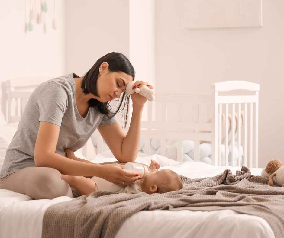 New mom gently looking at her postpartum body in the mirror, embracing changes after childbirth with confidence