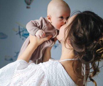 New mom gently holding her newborn with a calm expression—showing the slow, natural process of Bonding with Your Baby