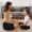 A mom sitting calmly with her child on the floor, smiling and making eye contact during a mindful parenting moment.