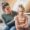 A calm mother kneeling at eye level, talking patiently to her upset child – Parenting with Patience in action.
