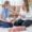 A Postpartum Body Changes, mom gently touching her belly while holding her newborn, reflecting on the changes her body has gone through.
