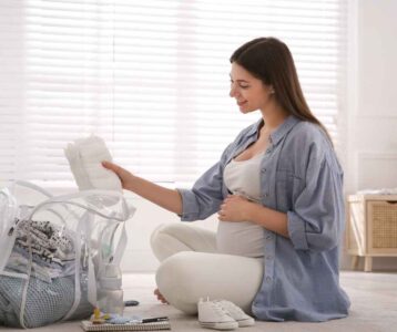 Open hospital bag checklist packed with essentials for mom, baby, and partner, including clothes, toiletries, and baby gear