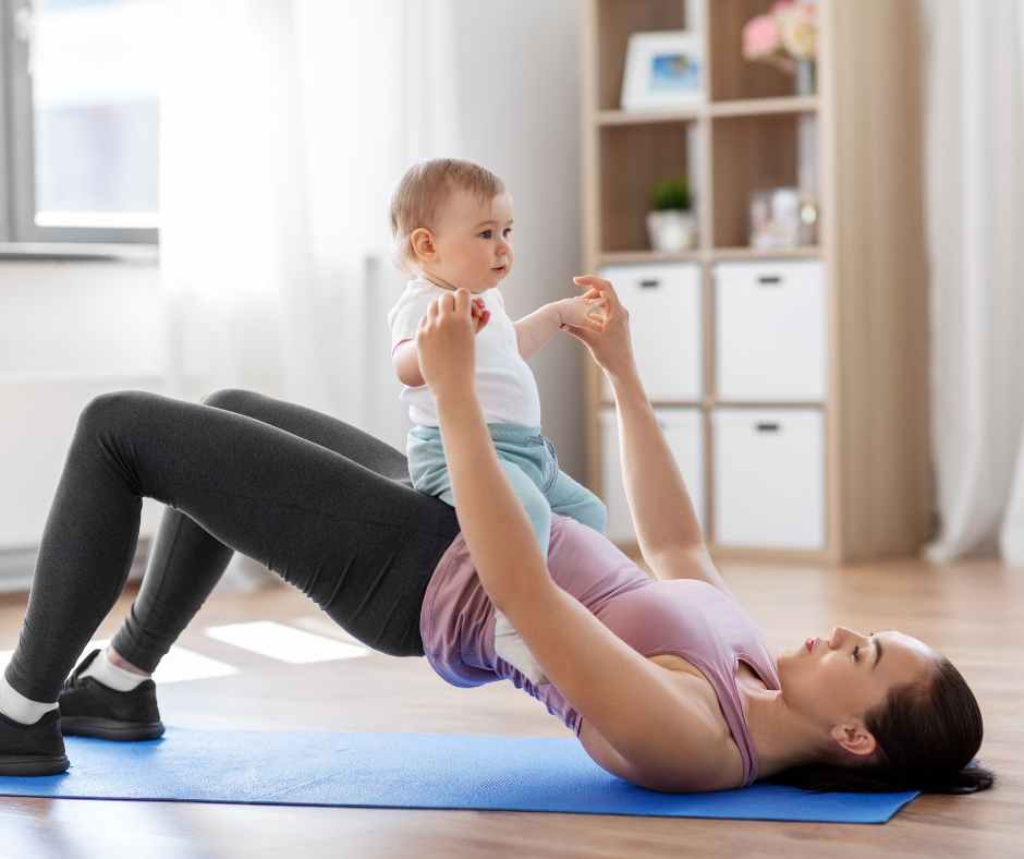 A mom sitting on a yoga mat practicing gentle pelvic floor exercises at home.
