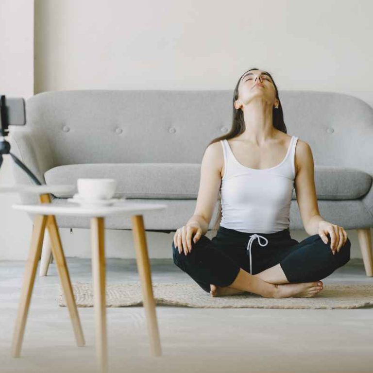 Busy mom doing a quick morning stretch at home while her child plays nearby — promoting 10-minute wellness habits for moms