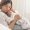 A new mom gently holding her baby while resting in bed after a cesarean section, focusing on healing and recovery.