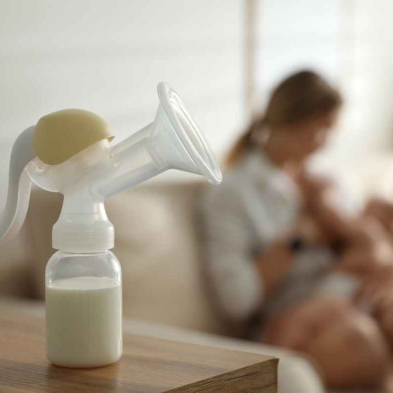 Mother choosing between breastfeeding and formula bottle – Breastfeeding vs. Formula comparison
