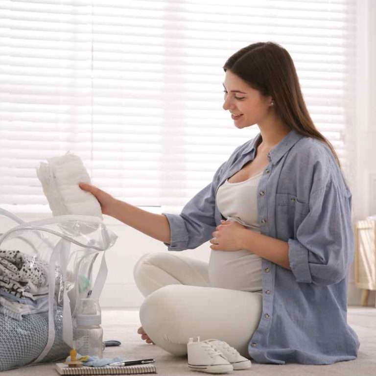 Open hospital bag checklist packed with essentials for mom, baby, and partner, including clothes, toiletries, and baby gear